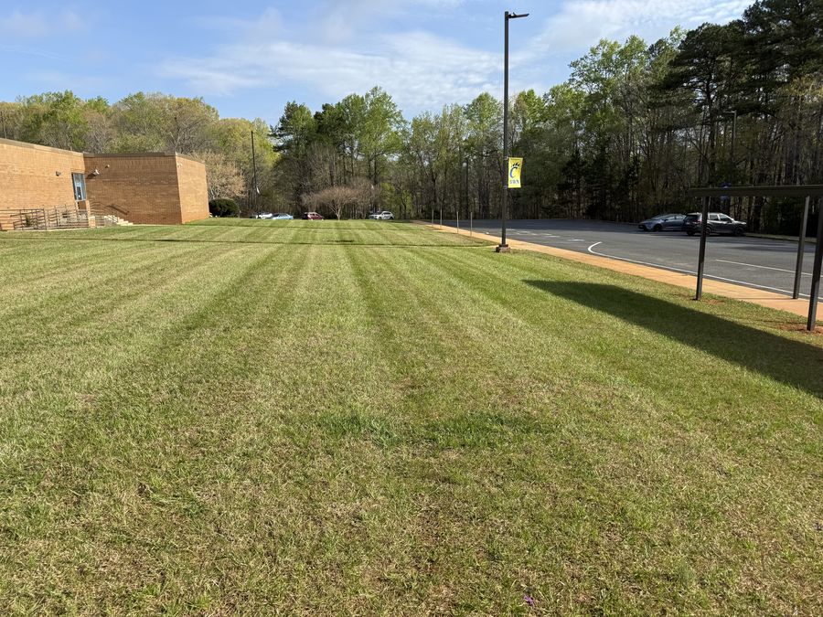 Freshly striped commercial lawn mowed by Alcazar Lawncare Services in High Point, NC