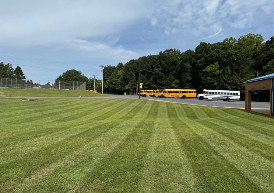 Neatly striped lawn maintained by Alcazar Lawncare Services in the Triad