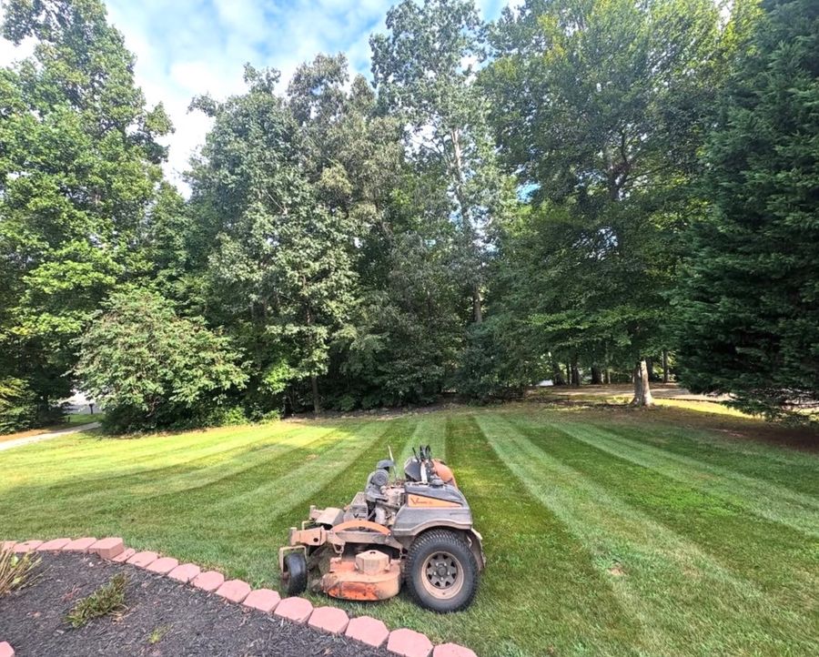Alcazar Lawncare Services commercial zero-turn mower on a freshly cut lawn